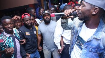Bobi surrounded by his security team with hands interlocked