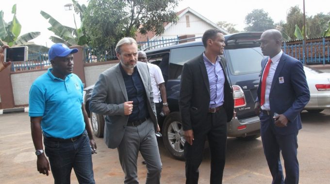 Desabre Sebastien (2nd Left) arriving at FUFA House accompanied by FUFA CEO, Edgar Watson & Spokesperson, Ahmed