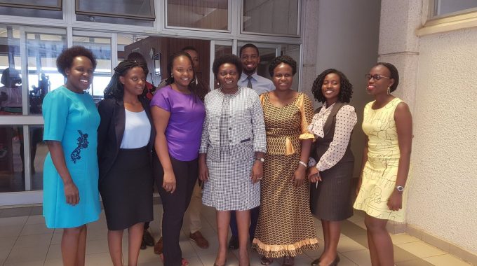 Minister Sarah Opendi (centre in grey suit) with Parliament media staff