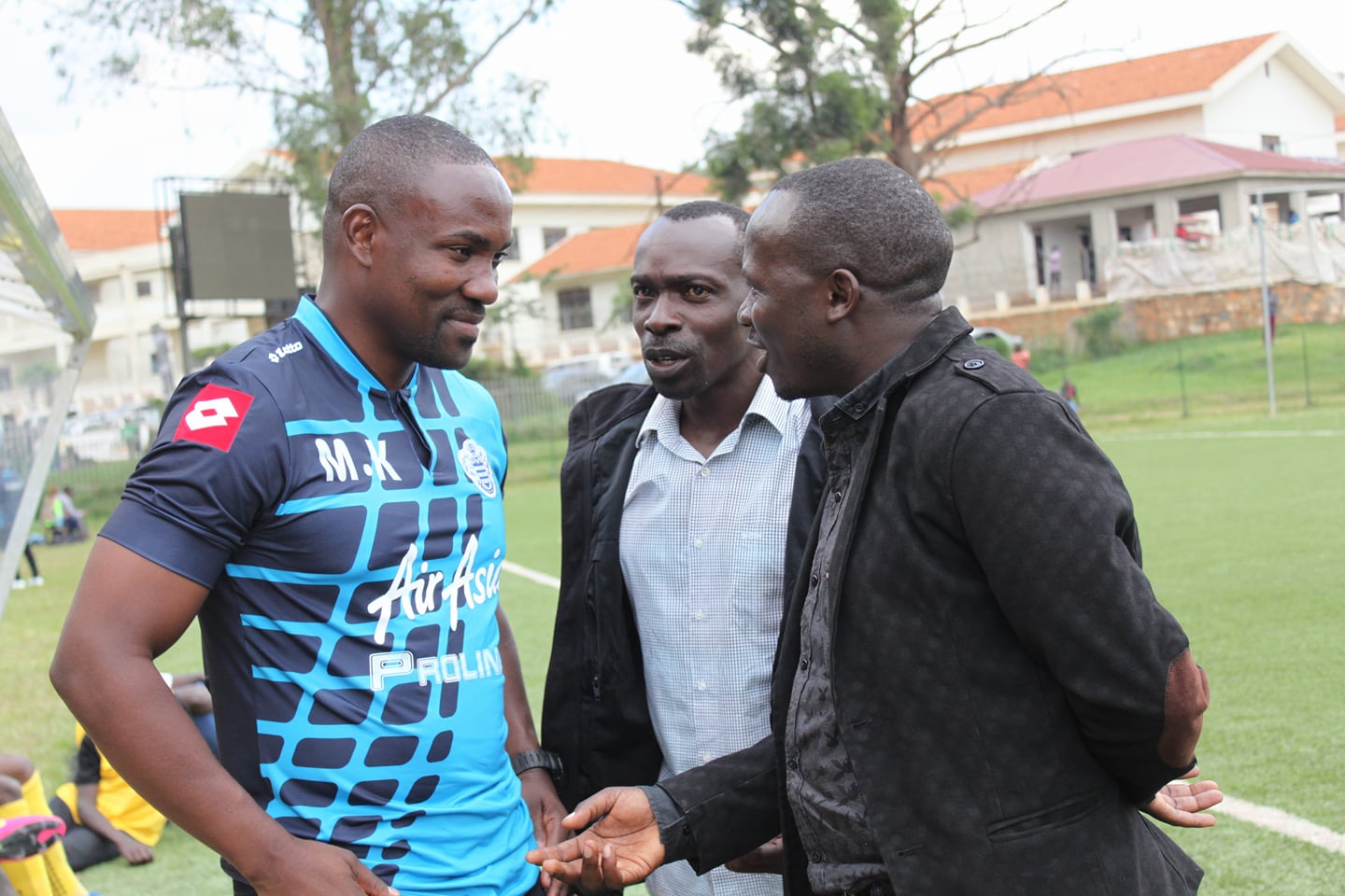 Mujib (L) interacting with fellow coaches after the game