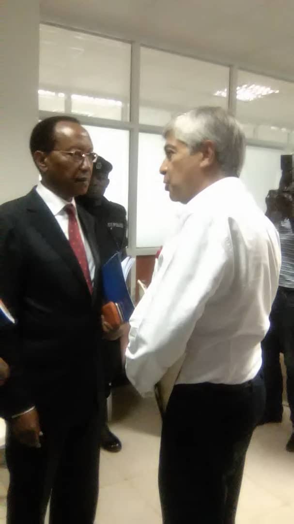 Nzeyi and his accuser shake hands after his grilling session at the Land Probe Commission in Kampala