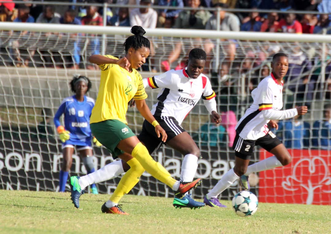 South Africa’s Jermaine Seoposonwe encounters Crested Cranes defenders Aluka Grace (Centre) and Namukisa Aisha (2)