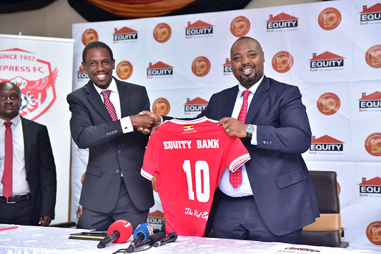 Kiryowa (L) handing over jersey to Equity bank boss after sponsorship deal