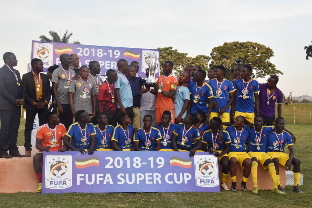 FUFA Super Cup 2019 winners KCCA FC recievingthe trophy from FUFA 2nd Vice President Darius Mugoye at Wankulukuku on Saturday