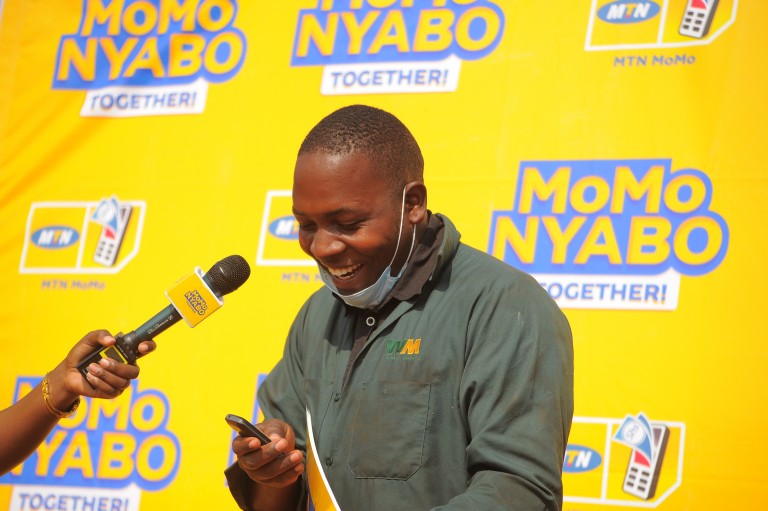 Kedi Kyate M Muzafaru reads out his Mobile Money Message fro MoMoNyabo in excitementuzafaru