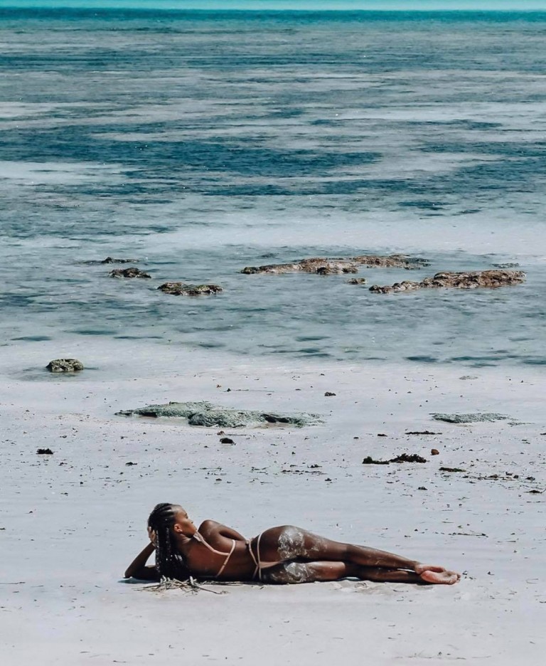 Sheilah eating money on baecation in Zanzibar fresh beach waters