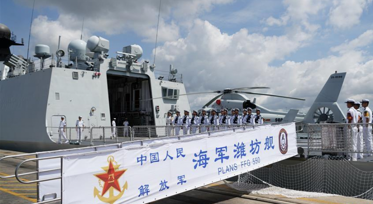 Chinese soldiers stand in formation aboard missile frigate Weifang