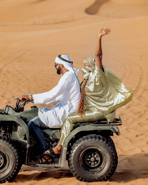 Rema and Hamza cruising on bike in Desert